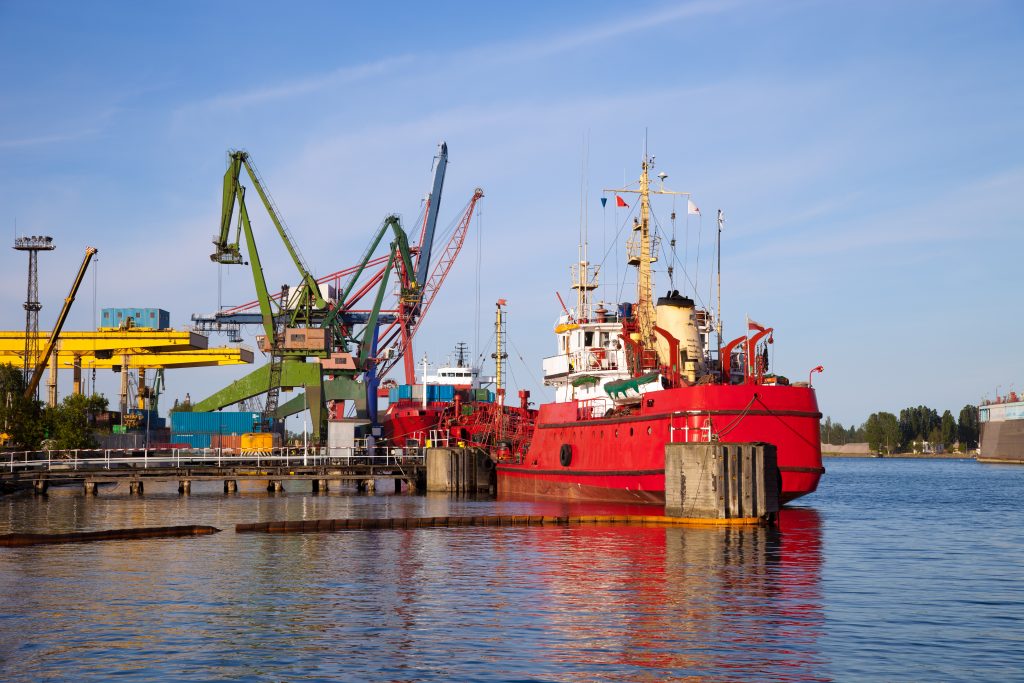 Cargo ship docked by the port