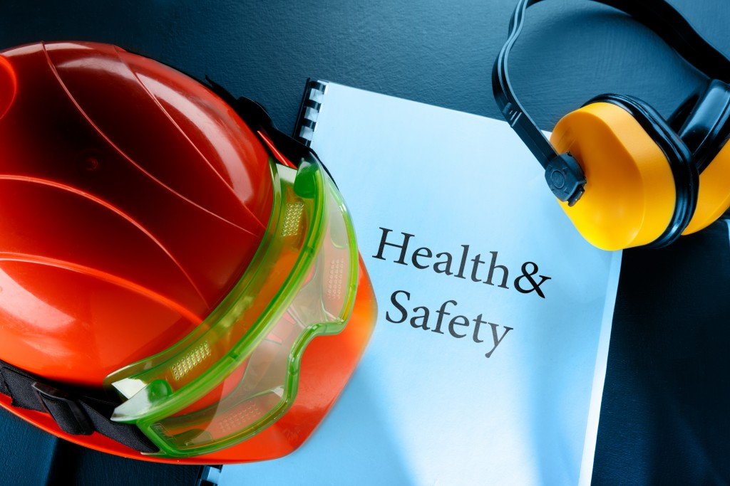 Safety hats and goggles over a health and safety book