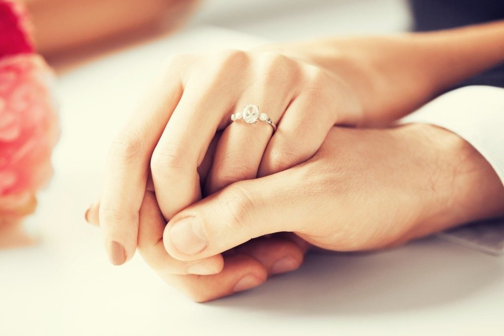 Holding Hands Showing Engagement Ring
