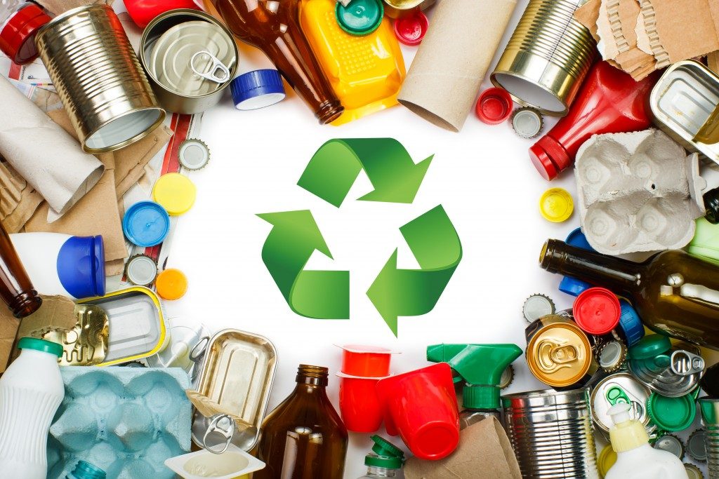 Recycle symbol with garbage around