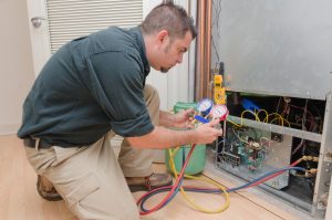 HVAC technician charging a heat pump