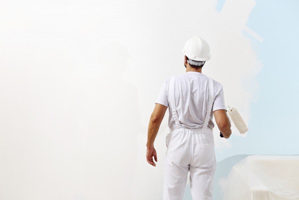 Man painting the office walls