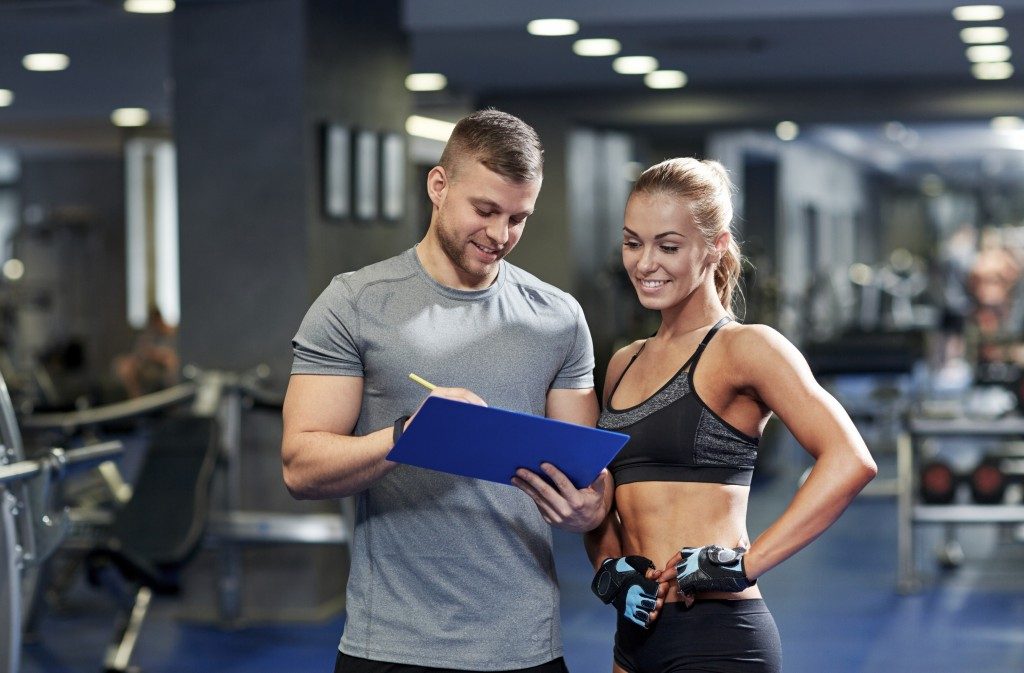 "Trainer and trainee looking at the clipboard