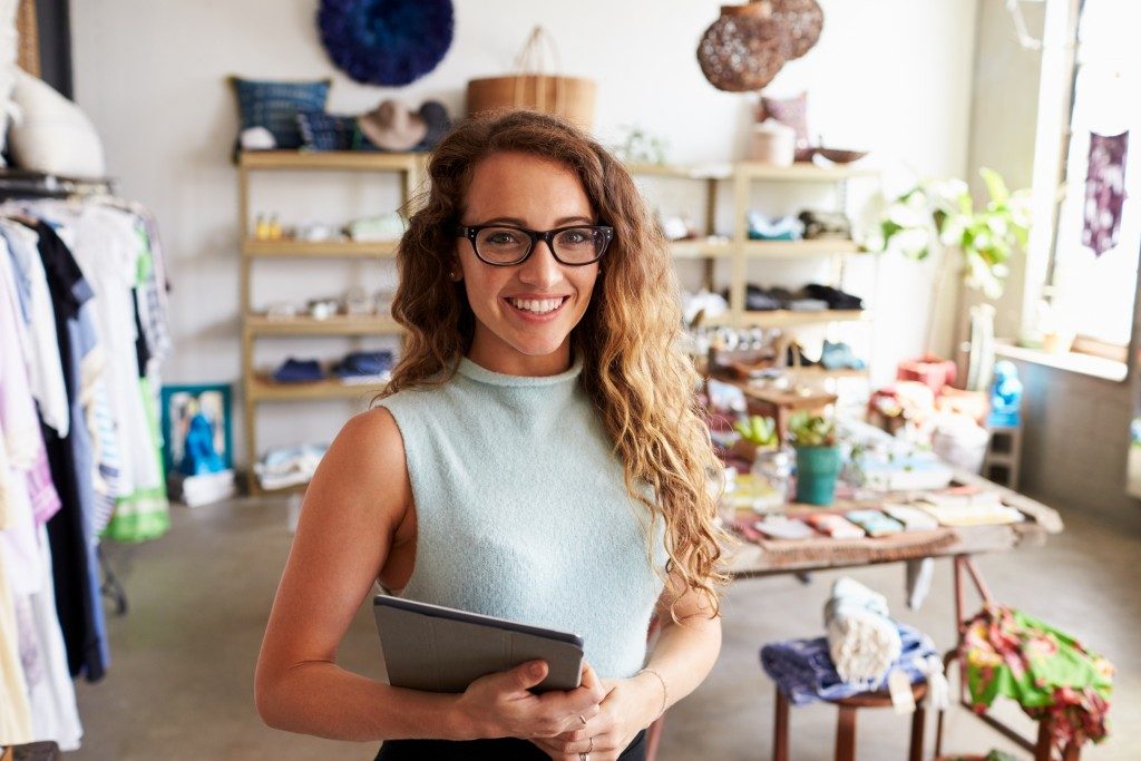 Clothes shop owner holding a tablet
