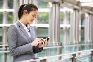 Woman sending email via phone