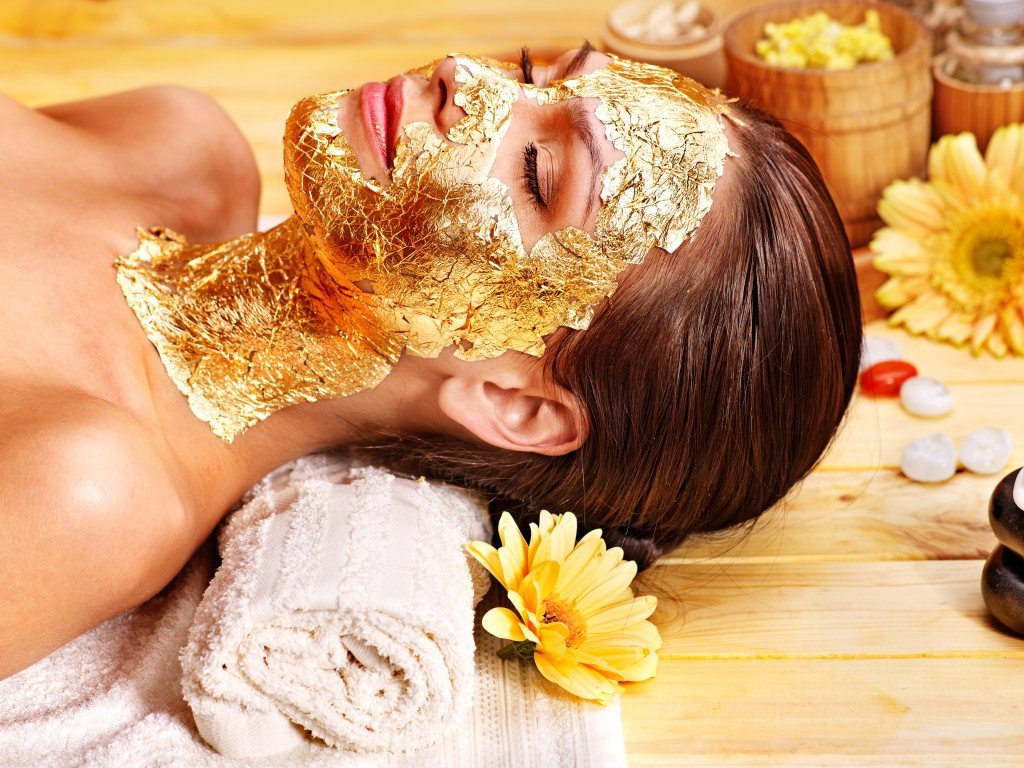 Gold facial mask on woman