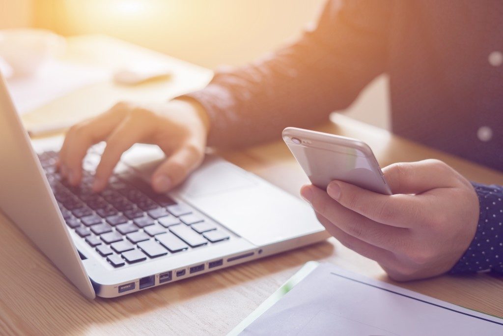 Businessman working with laptop and phone