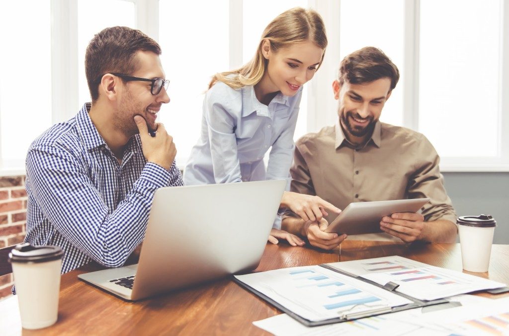 Business people looking at the tavlet in a working environment