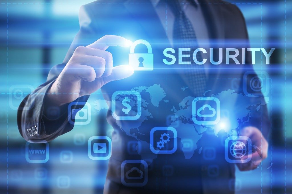 Businessman holding the virtual lock button