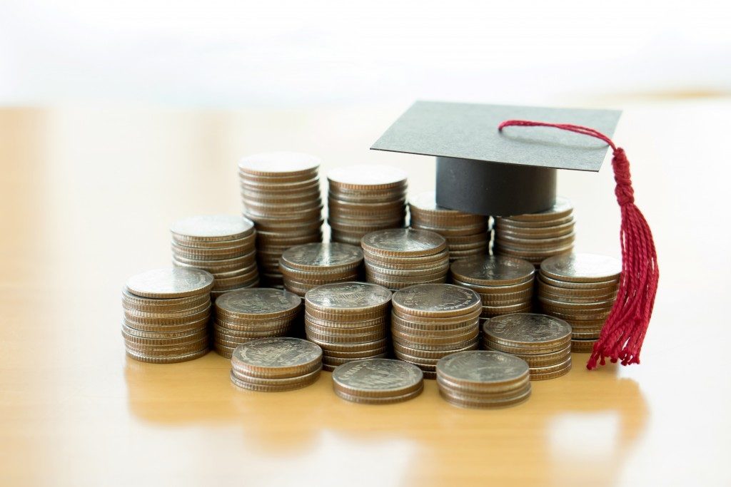 student loan concept, toga and coins