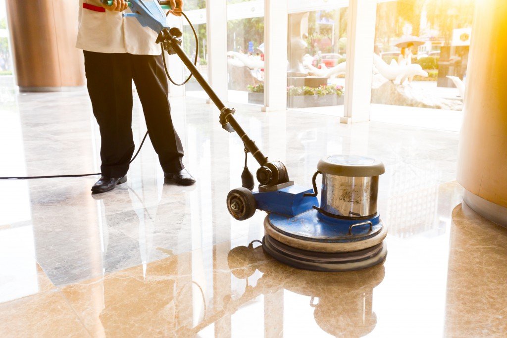 Man cleaning polishing commercial building floors