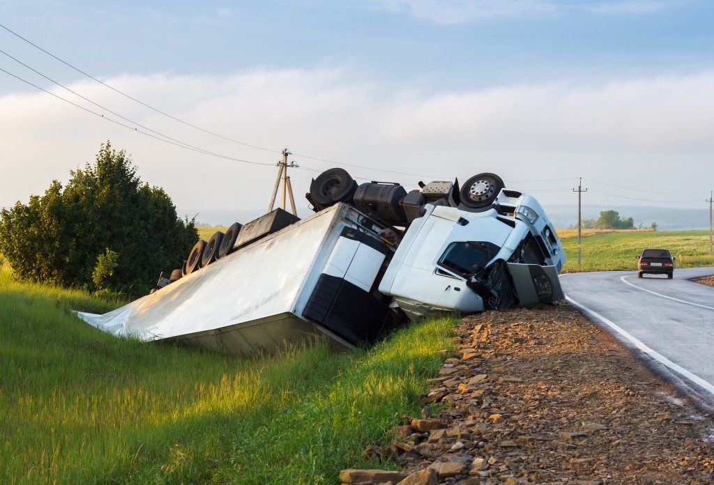 The truck lies in a ditch after the road accident
