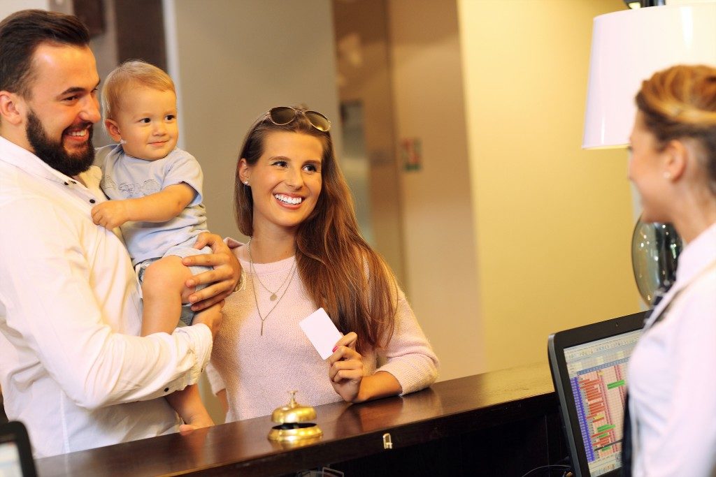 Family checking in hotel