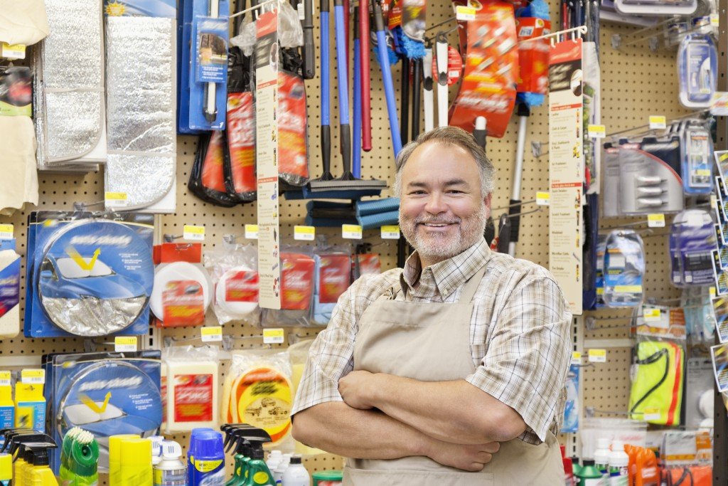 store owner posing near his products
