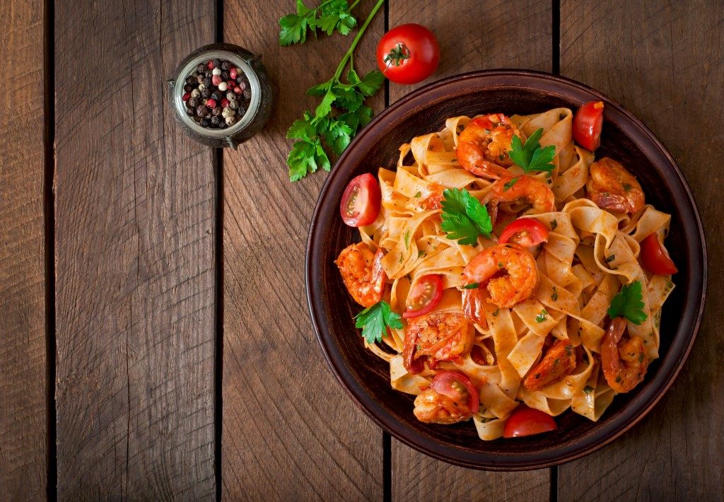 tomato pasta on top of wooden table