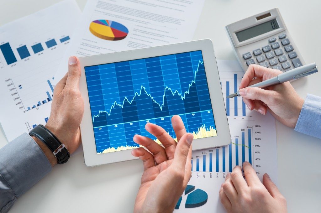 Business people discussing graph together in the office