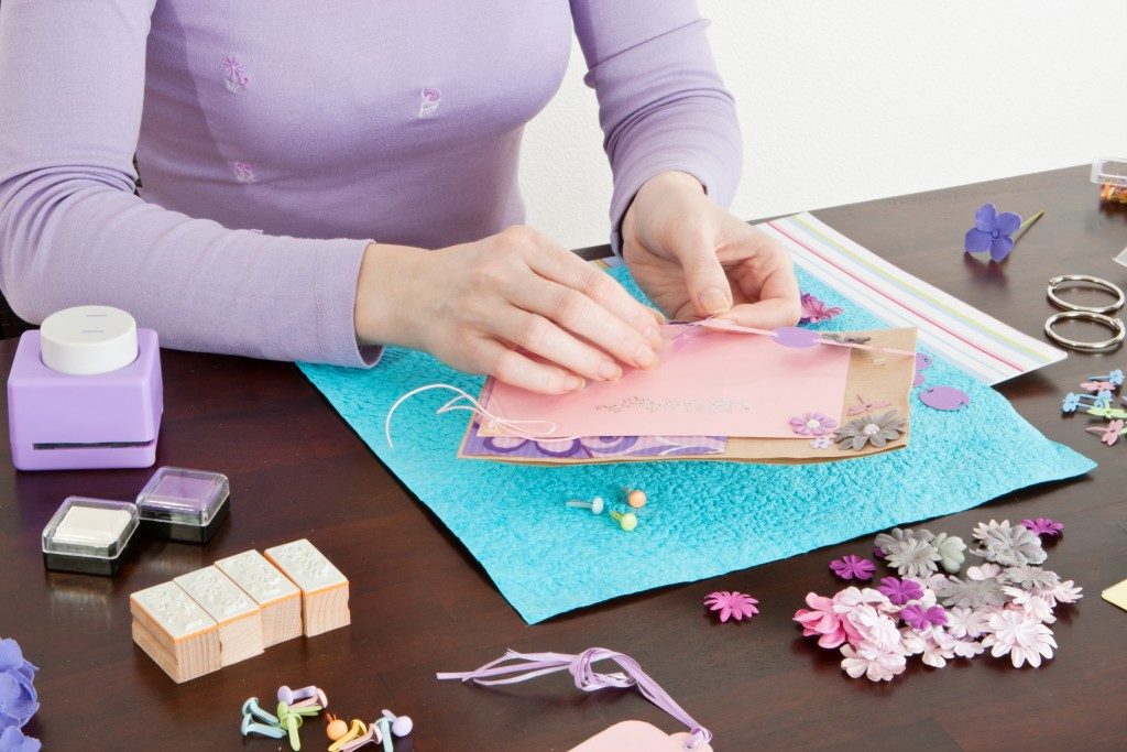 woman making a scrapbook
