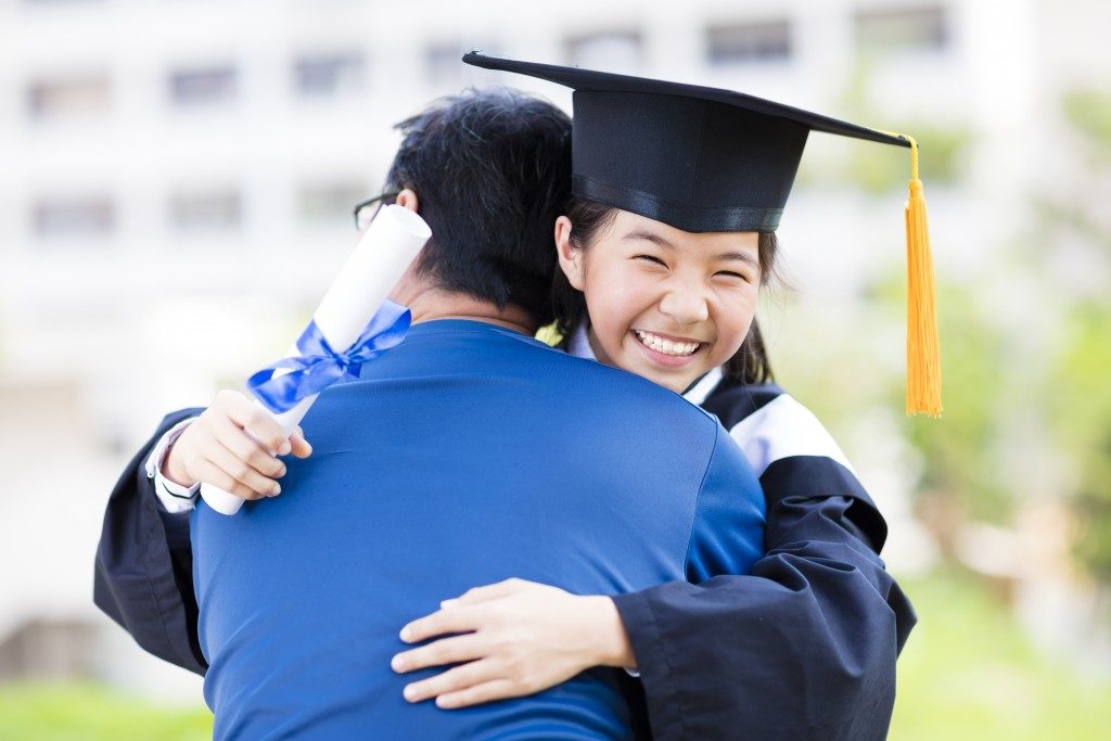 Graduate hugging her dad