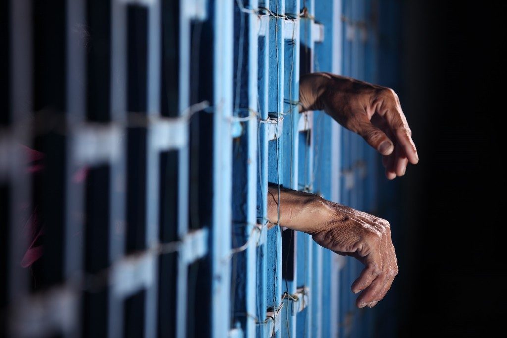 Prisoner behind bars