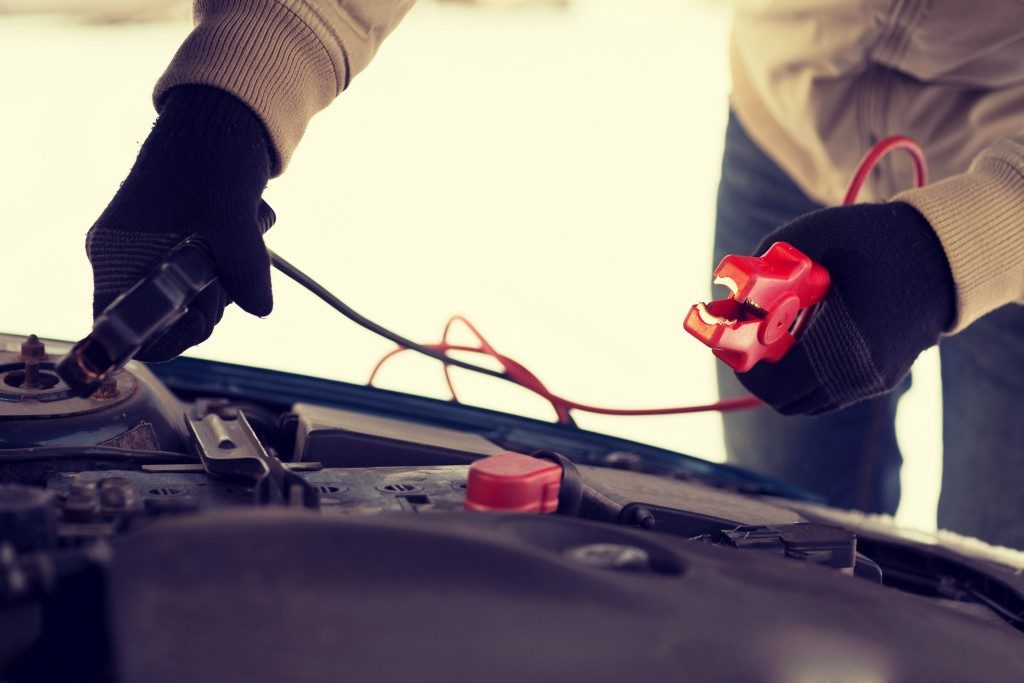 man repairing jumper cables