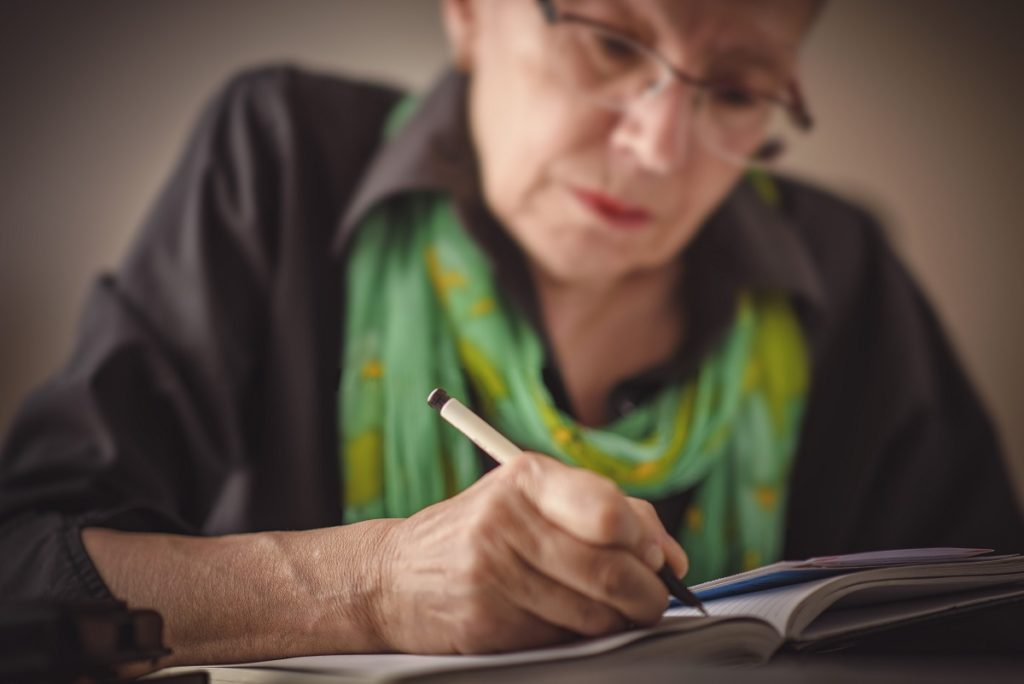 Old woman writing a letter