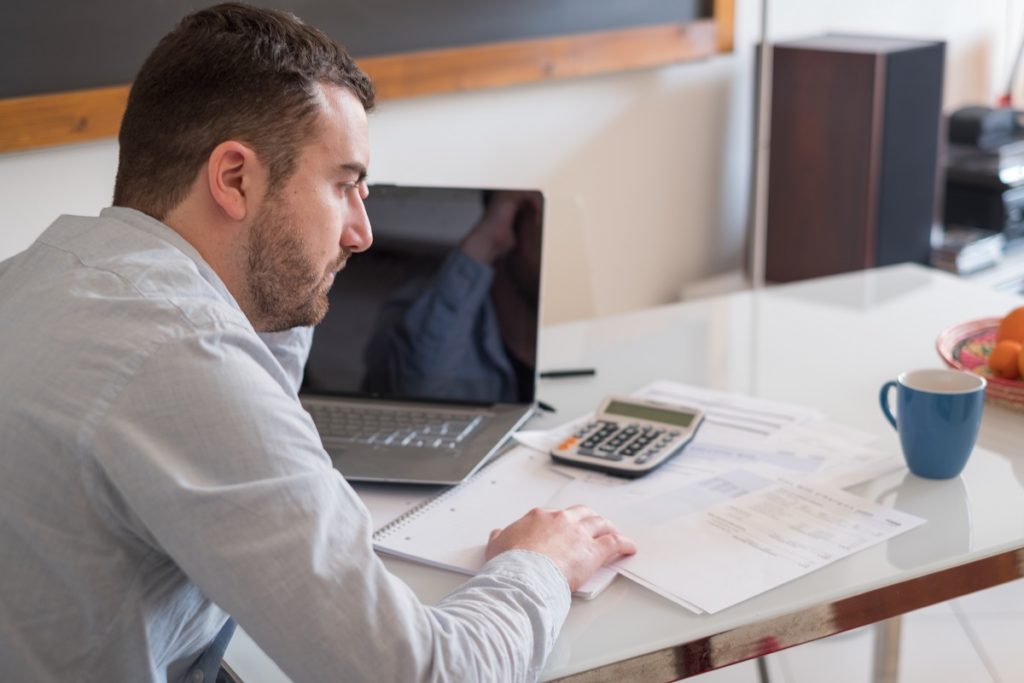 man computing his expenses