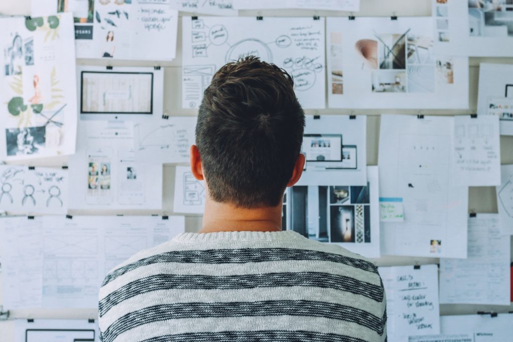 man looking at an idea board